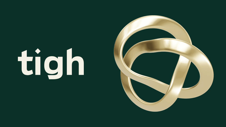 The new Tigh wordmark beside the brass ribbon sculpture from tighsauna.com, on evergreen